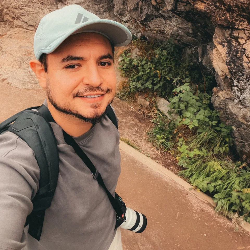 Cesar Jimenez with his camera on a hiking trail